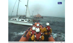 Lifeboat crews reach the sinking yacht 