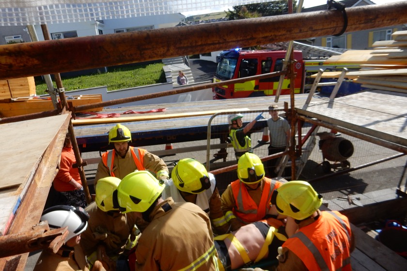 The Workman is rescued from the building by Fire Crews