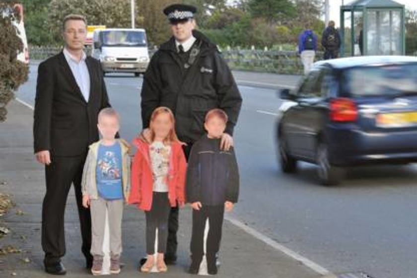 Cardboard cutouts of children to deter speeding