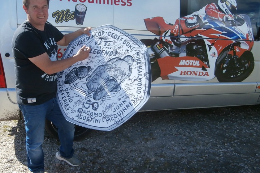 John McGuinness signs the coin