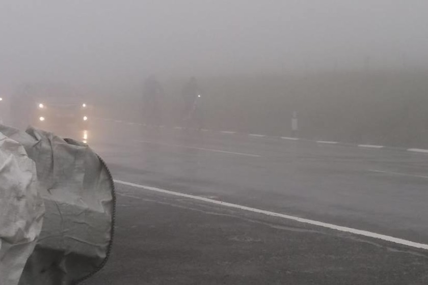 Cyclists were barely visible on the Mountain Road in foggy conditions yesterday