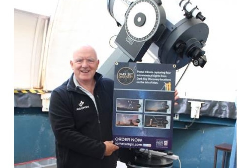 Howard Parkin at the Isle of Man Observatory with a poster of the stamps