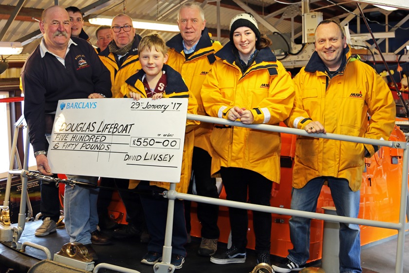 David Livsey presents the cheque to Douglas's lifeboat crew.
