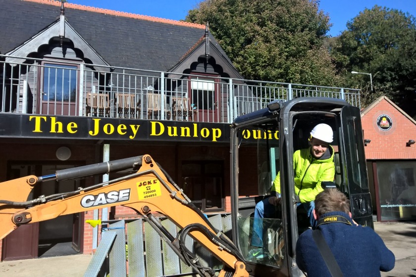 Jonathan Rea digs the first foundations for new apartments at the Joey Dunlop Foundation.