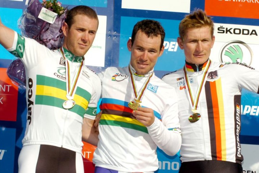 Mark Cavendish (centre) collecting the World Champion's rainbow jersey (picture from roadcycling.com)