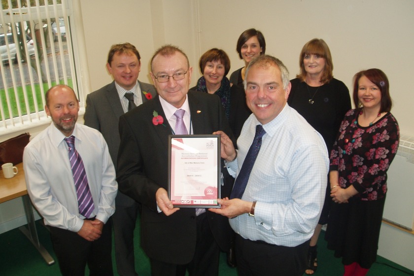 Social Care political member Bill Malarkey presents to certificate of accreditation