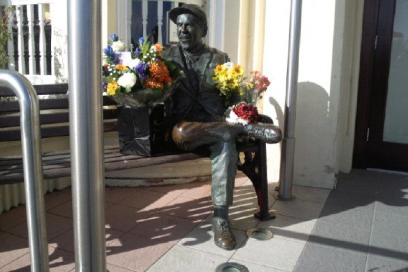 Tributes have been left at the statue of Sir Norman outside the Sefton this morning