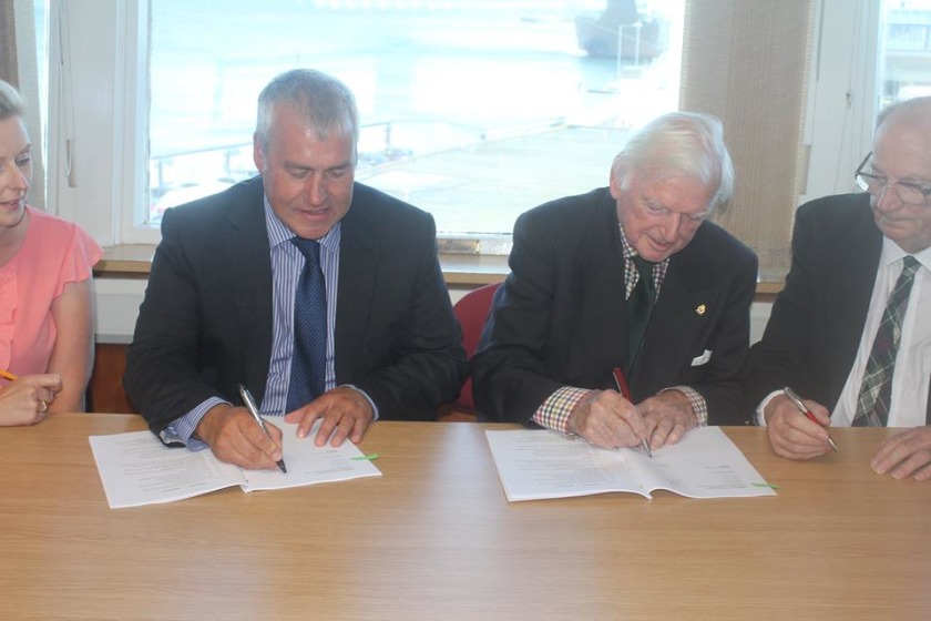 Infrastructure Minister Ray Harmer signed the lease allowing the Queen's Pier Restoration Trust to begin work on the structure.