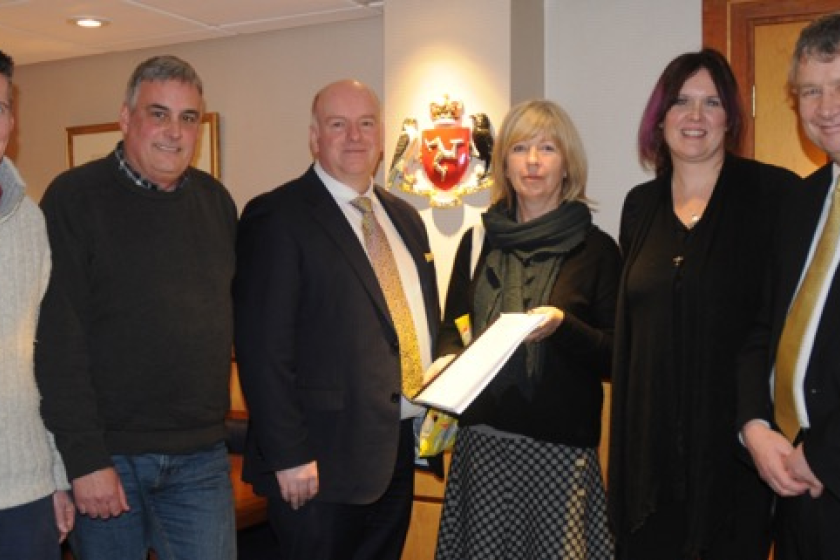 Representatives from the groups behind the petition present the signatures to Chief Minister Howard Quayle and Policy and Reform Minister Chris Thomas.